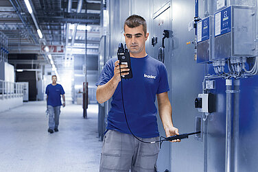 Leadec employee checking performance of utilities.