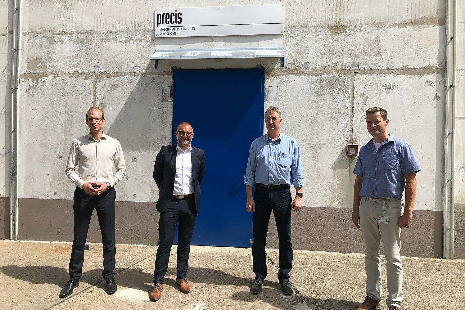 Representatives of Leadec and Precis in front of the Precis building.