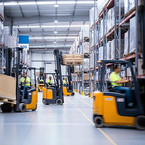 Several forklift trucks in a warehouse
