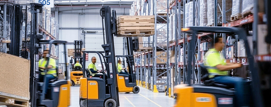 Several forklift trucks in a warehouse