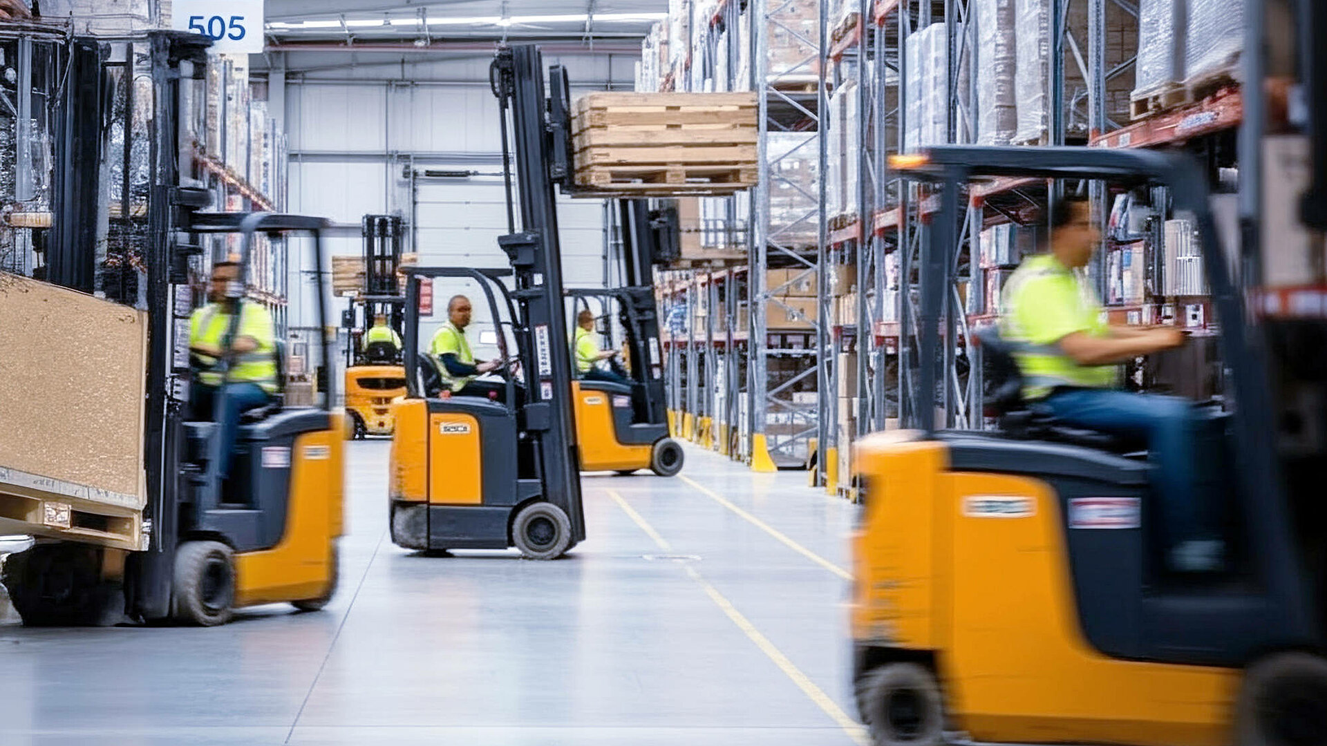 Several forklift trucks in a warehouse