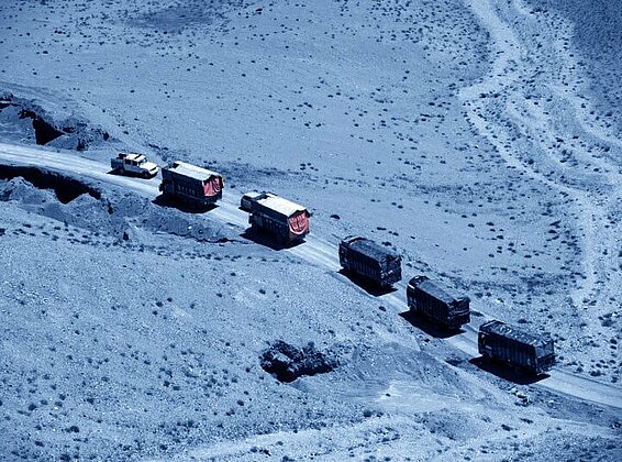 Convoy of trucks driving in the desert.