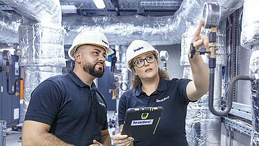 Two Leadec employees inspecting thermal power station.