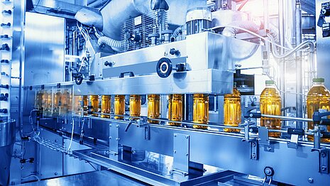 Conveyor belt with bottles in the bottling line.