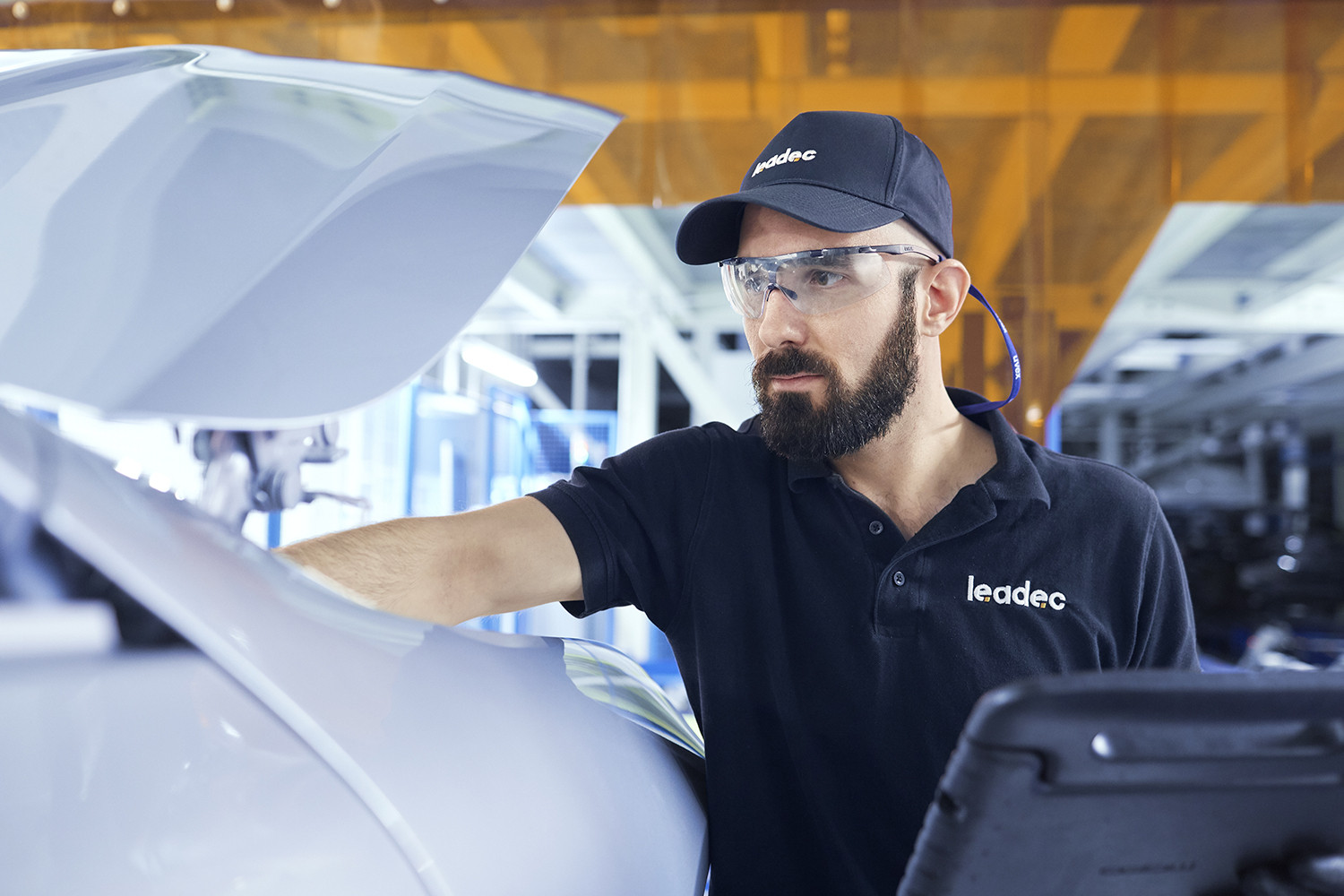 A Leadec employee troubleshooting a conveyor system.