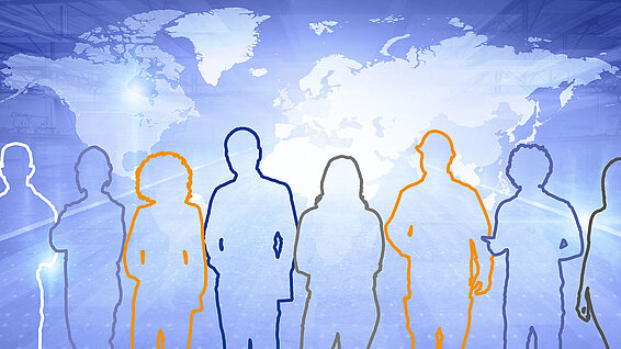 Outlines of several people in front of a world map, symbolizing diversity.