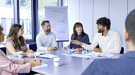 Group of Leadec employees at a meeting in conference room.