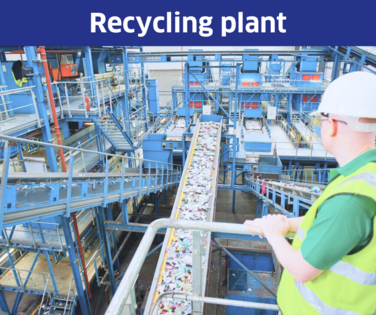 Man standing at a railing in a recycling plant.