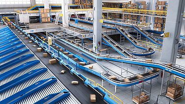 Conveyor belts with parcels in a parcel distribution center.