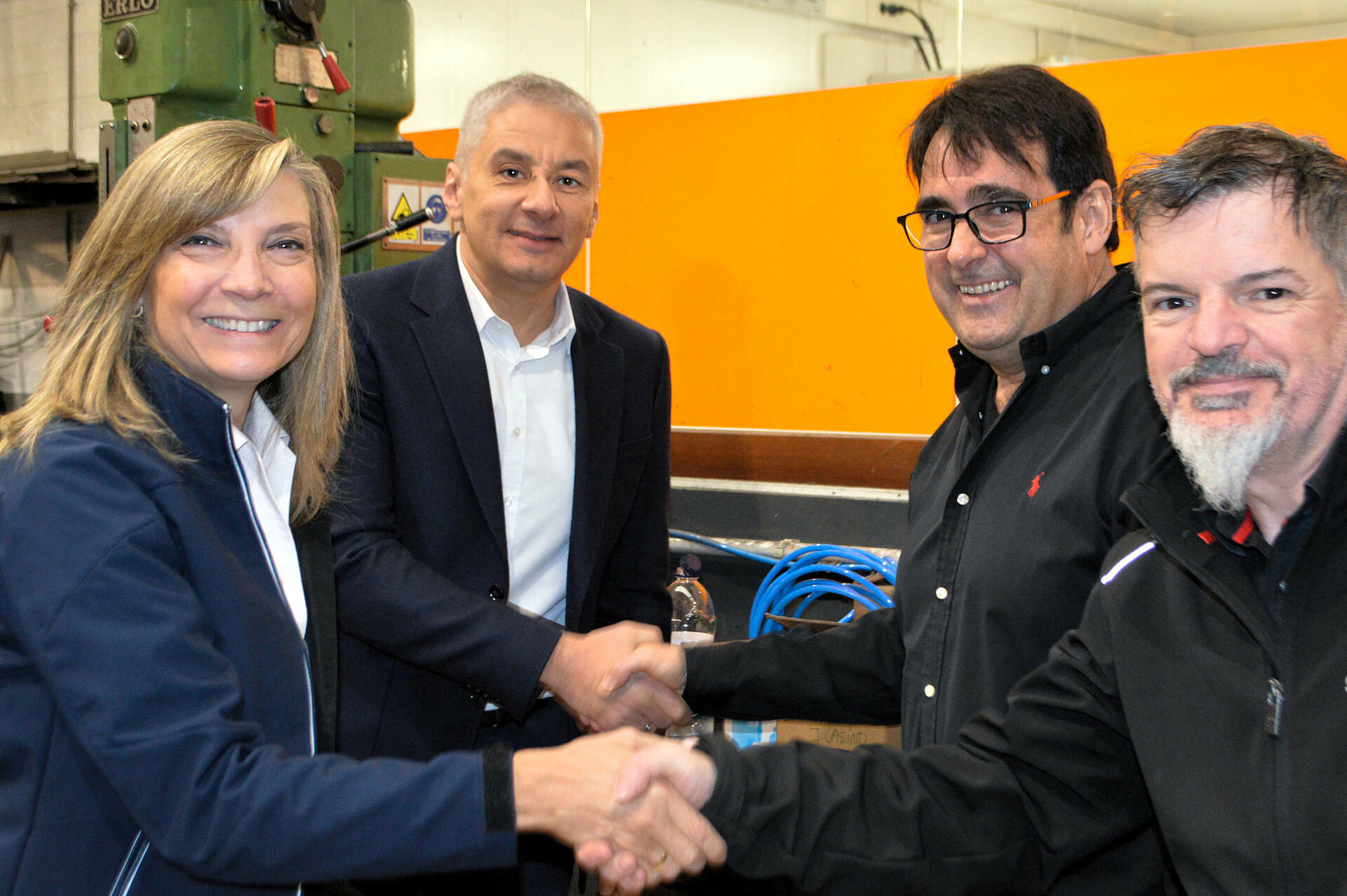 Four people from Leadec and Servycat management shaking hands