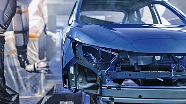 Blue vehicle body in a paint shop.