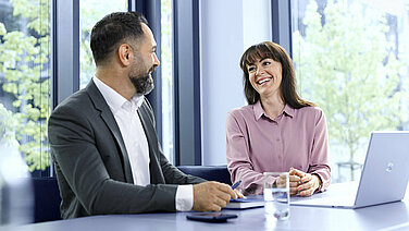 Two Leadec employees at a meeting in conference room.